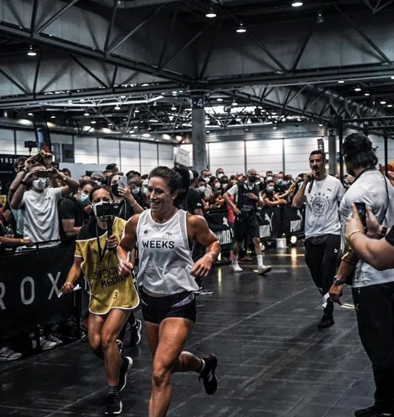 An athlete runs into the race arena through the crowd