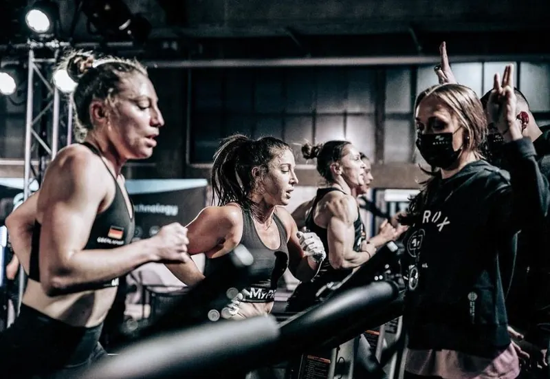 Athletes running side by side on treadmills during a race