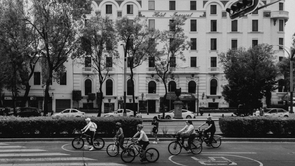 Commuting by bike in winter: a group of cyclists riding along a city bike lane